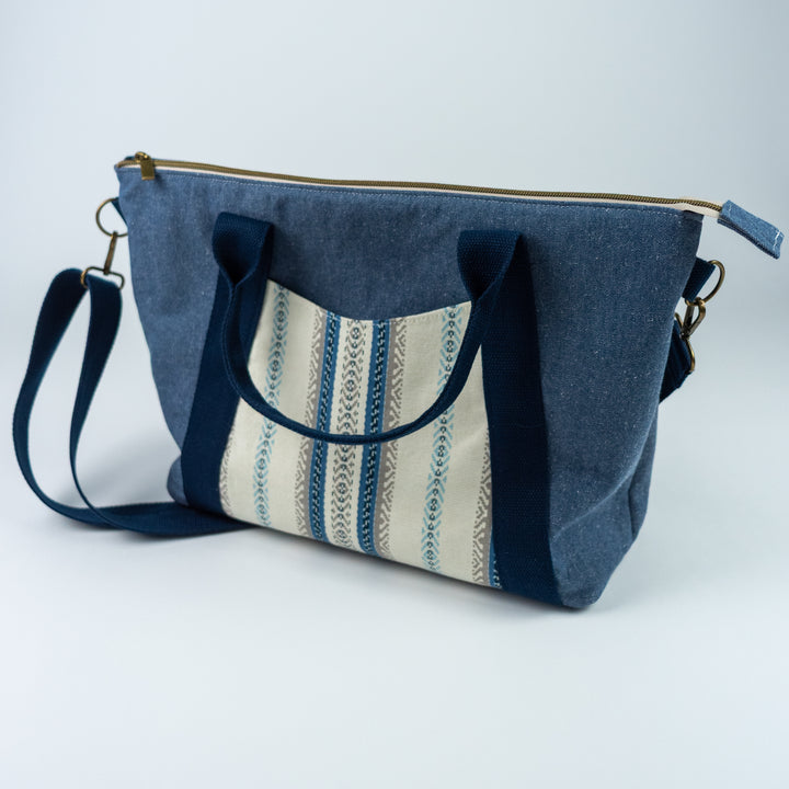 Blue fabric bag with striped pattern on a white background