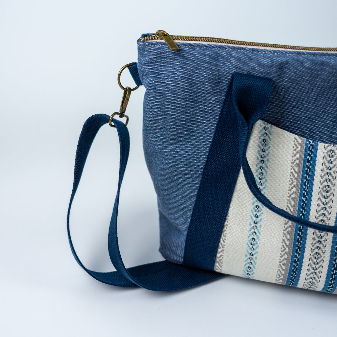 Blue fabric bag with a strap on a white background