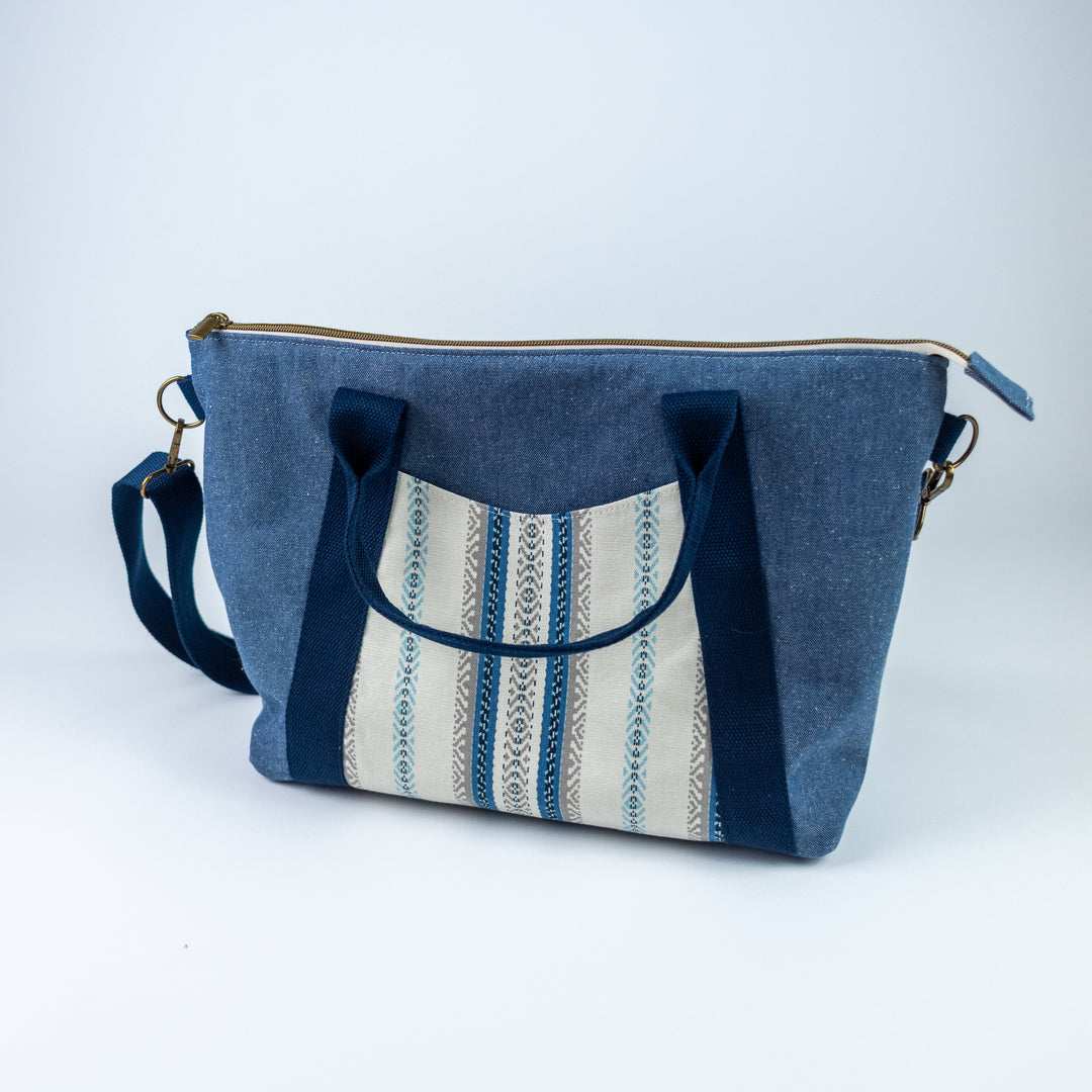Blue fabric bag with striped pattern on a white background