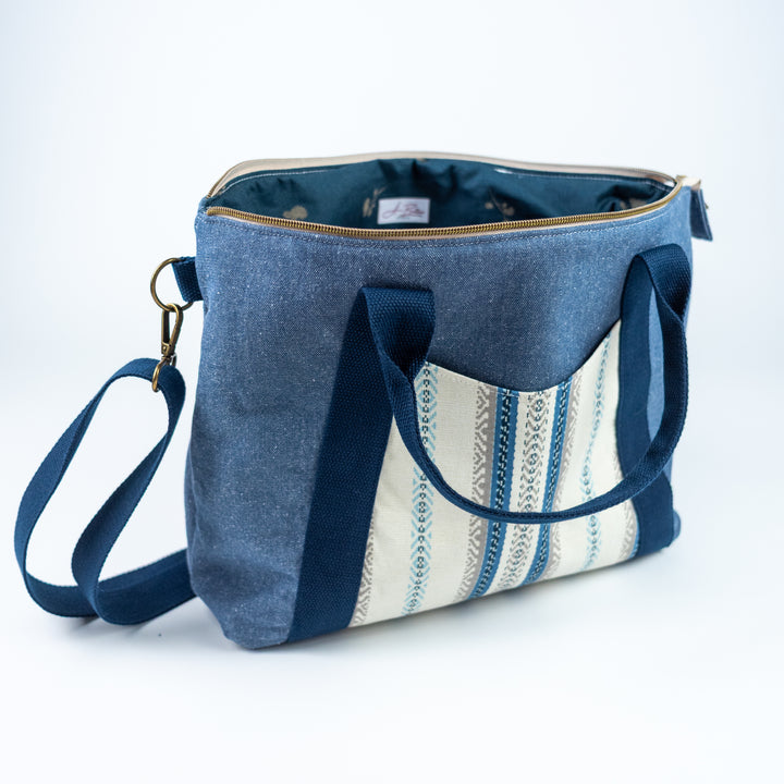 Blue tote bag with striped pattern on a white background