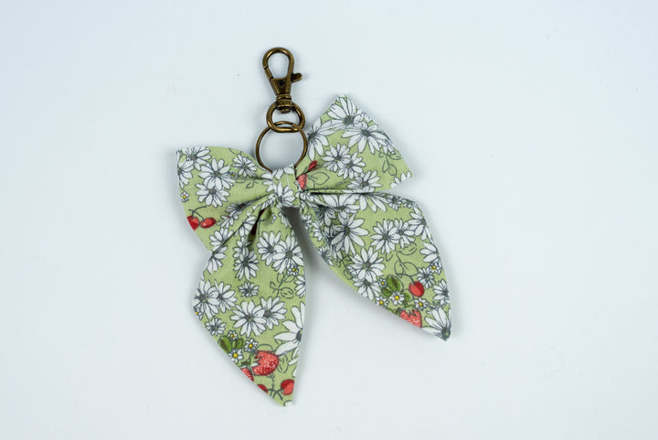 Floral fabric bow keychain on a white background