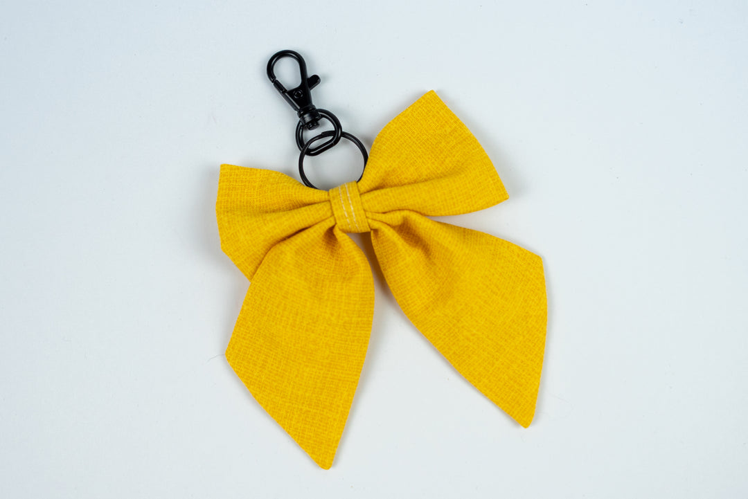 Yellow bow keychain on a white background