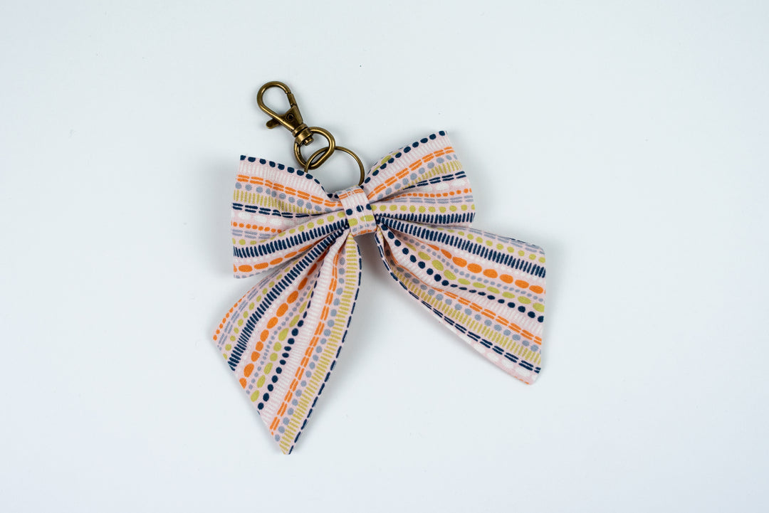 Keychain with a striped bow on a white background