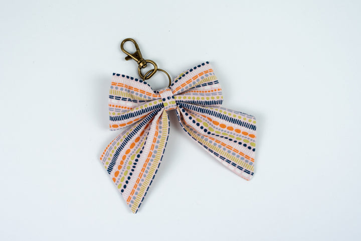 Keychain with a striped bow on a white background