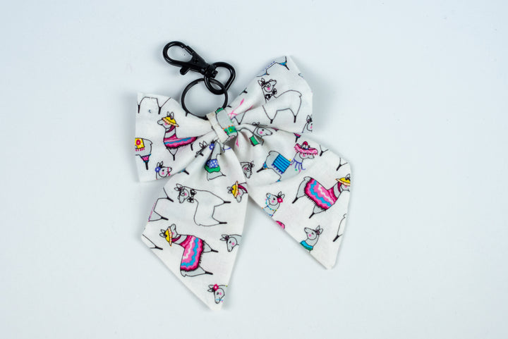 Bow keychain with colorful llamas on a white background