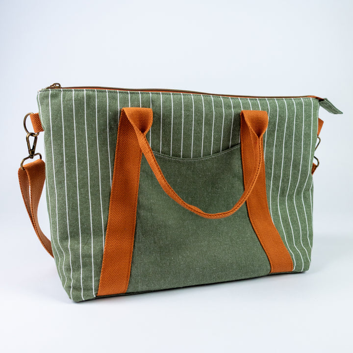 Green striped bag with orange handles and straps on a white background